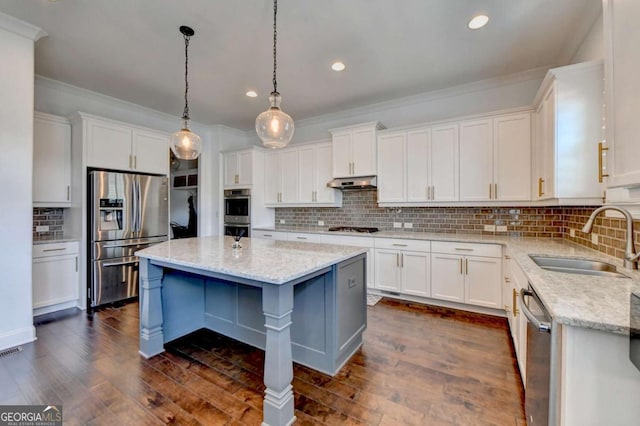 828 Olmsted Ln, Duluth, GA 30097 - kitchen featuring stainless steel appliances, a sink, crown molding, under cabinet range hood, and decorative backsplash