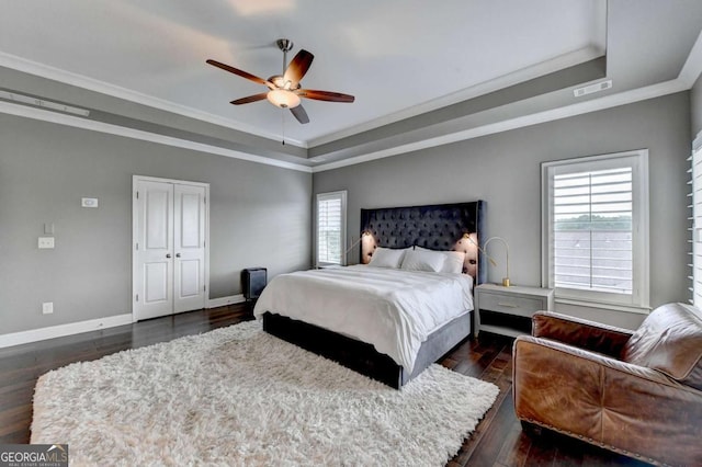 828 Olmsted Ln, Duluth, GA 30097 - bedroom with a raised ceiling, multiple windows, dark wood-type flooring, baseboards, and crown molding