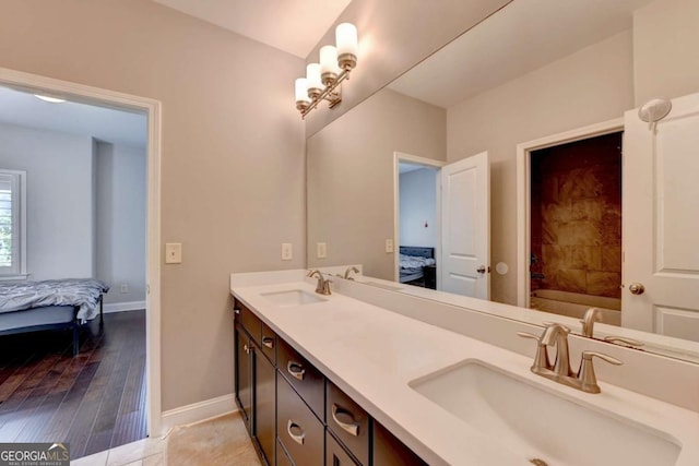 828 Olmsted Ln, Duluth, GA 30097 - full bathroom featuring connected bathroom, baseboards, double vanity, hardwood / wood-style flooring, and a bathtub