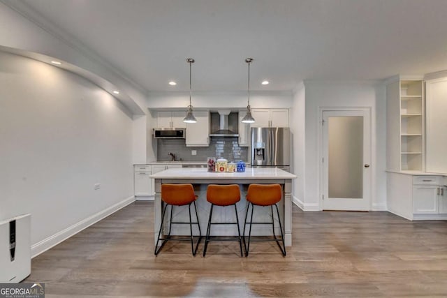 828 Olmsted Ln, Duluth, GA 30097 - kitchen featuring appliances with stainless steel finishes, wall chimney exhaust hood, white cabinets, baseboards, and a kitchen island