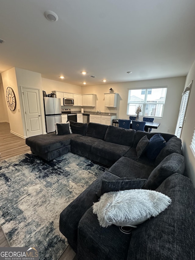 living room with wood finished floors and recessed lighting