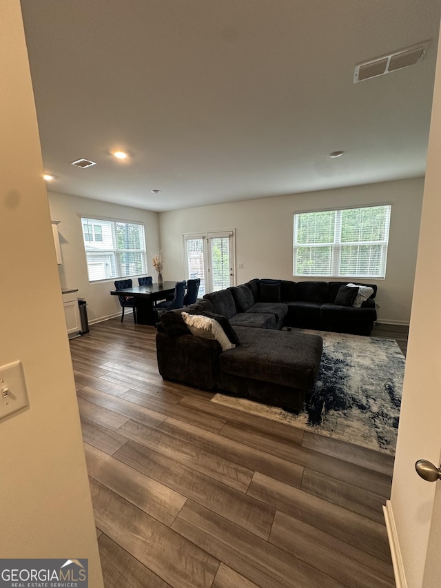 living room featuring wood finished floors, recessed lighting, and baseboards
