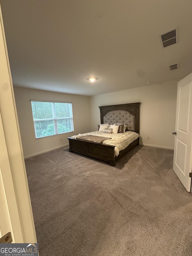 carpeted bedroom with baseboards