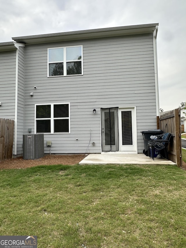 back of property with a patio and central AC