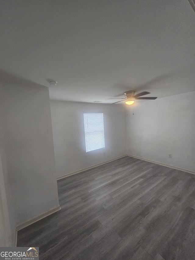 7253 Lacey Dr, Douglasville, GA 30134 - empty room featuring ceiling fan, dark wood-style floors, and baseboards