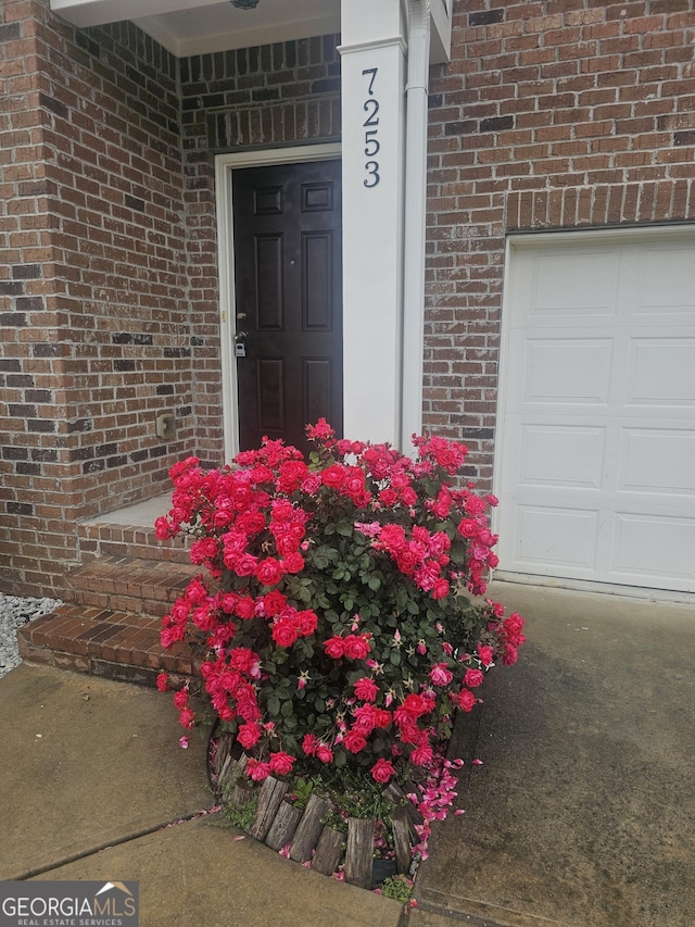7253 Lacey Dr, Douglasville, GA 30134 - doorway to property with brick siding and a garage