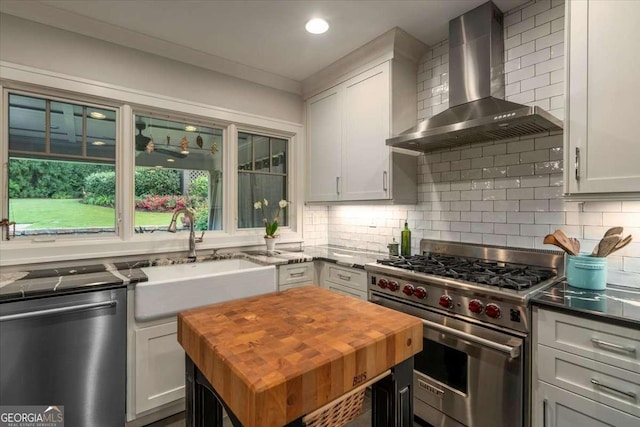 430 Milledge Cir, Athens, GA 30609 - kitchen with luxury range, dishwasher, wall chimney exhaust hood, wooden counters, and a sink