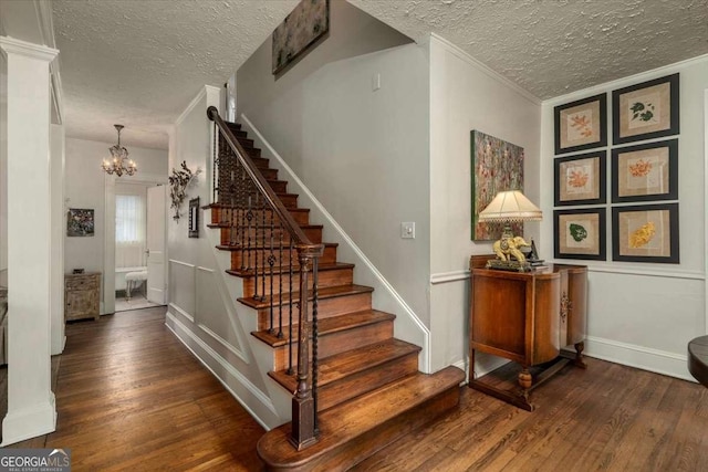 430 Milledge Cir, Athens, GA 30609 - stairs featuring a textured ceiling, wood finished floors, a chandelier, and ornamental molding