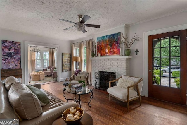 430 Milledge Cir, Athens, GA 30609 - living area featuring wood finished floors, a fireplace, a textured ceiling, a ceiling fan, and ornamental molding