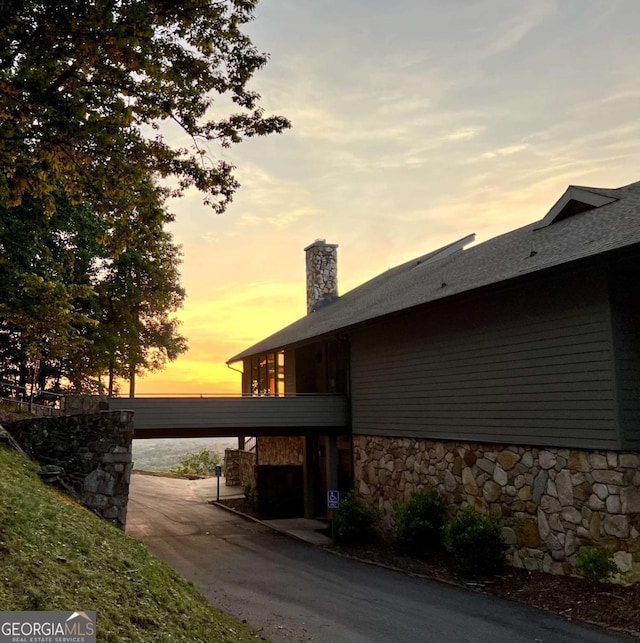 223 Denny Ridge Rd, Jasper, GA 30143 - property exterior at dusk with stone siding and a chimney