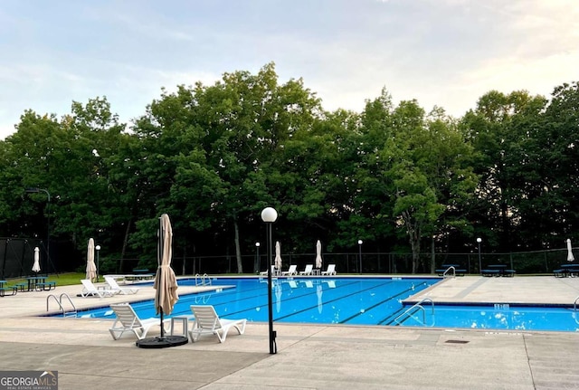 223 Denny Ridge Rd, Jasper, GA 30143 - community pool featuring fence, a patio area, and view of wooded area