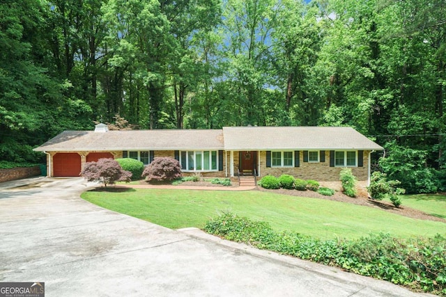 single story home featuring driveway, an attached garage, a front lawn, and a chimney