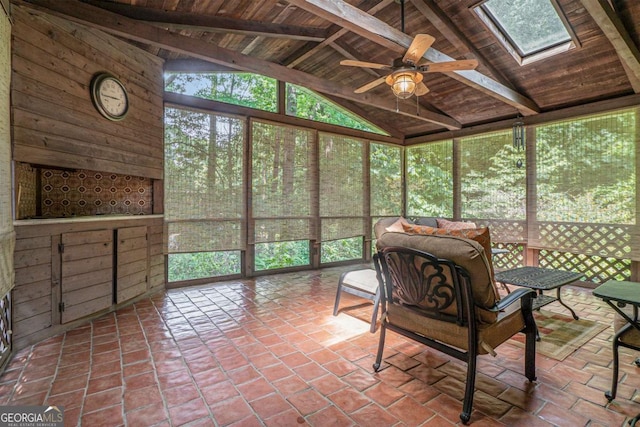 sunroom with a ceiling fan and a skylight