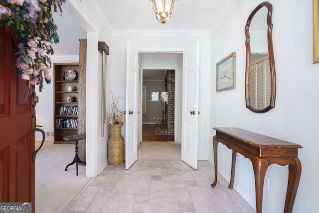 entrance foyer with baseboards, crown molding, and a chandelier