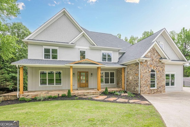 2555 Chattahoochee Ln, Cumming, GA 30041 - craftsman-style house featuring a porch, roof with shingles, driveway, a front lawn, and board and batten siding