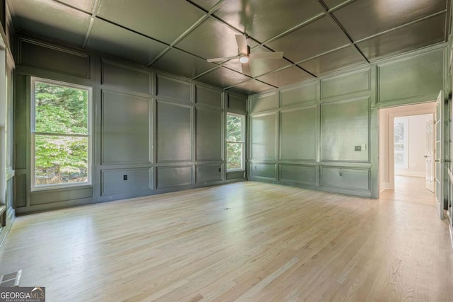 2555 Chattahoochee Ln, Cumming, GA 30041 - spare room featuring a decorative wall, wood finished floors, and a ceiling fan