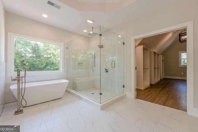 2555 Chattahoochee Ln, Cumming, GA 30041 - bathroom with a marble finish shower, a freestanding bath, marble finish floors, recessed lighting, and a spacious closet