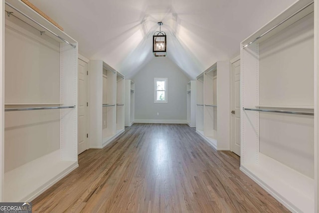 2555 Chattahoochee Ln, Cumming, GA 30041 - walk in closet featuring light wood-type flooring and vaulted ceiling