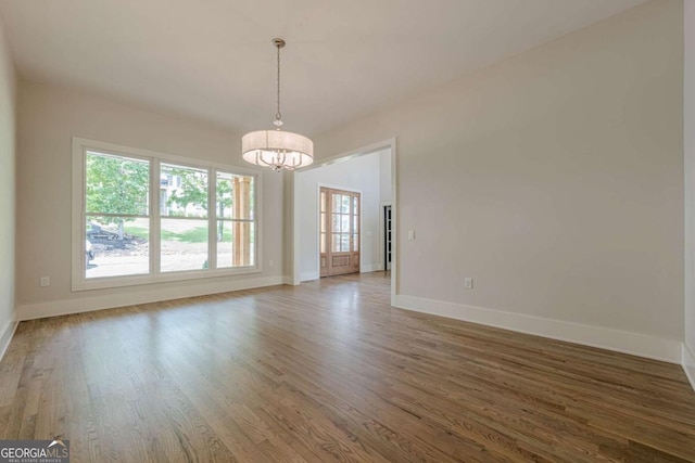 2555 Chattahoochee Ln, Cumming, GA 30041 - spare room featuring a chandelier and wood finished floors