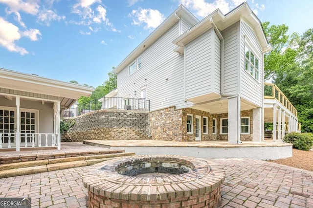 2555 Chattahoochee Ln, Cumming, GA 30041 - view of patio / terrace featuring an outdoor fire pit and stairway