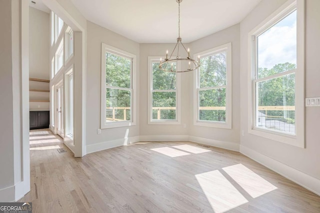 2555 Chattahoochee Ln, Cumming, GA 30041 - unfurnished dining area featuring a chandelier and light wood-type flooring