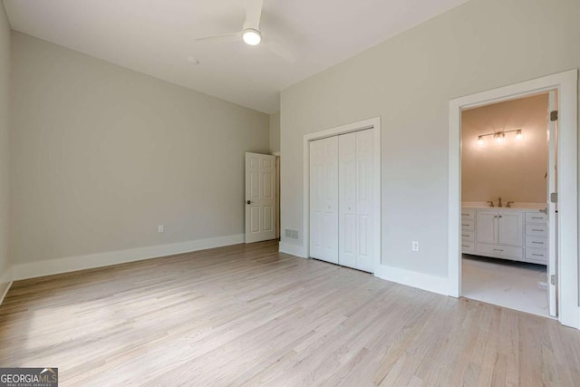 2555 Chattahoochee Ln, Cumming, GA 30041 - unfurnished bedroom featuring light wood-style floors, a closet, connected bathroom, and ceiling fan