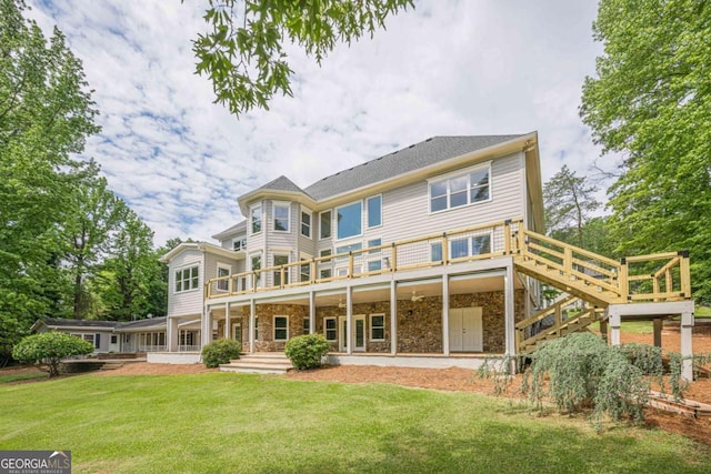 2555 Chattahoochee Ln, Cumming, GA 30041 - back of house featuring a lawn, stone siding, a wooden deck, and stairs