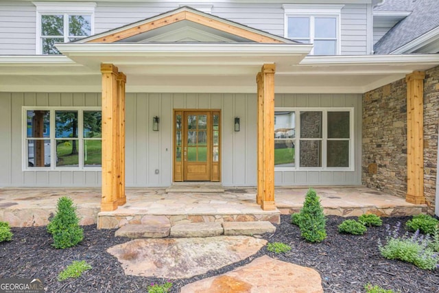 2555 Chattahoochee Ln, Cumming, GA 30041 - doorway to property featuring covered porch, roof with shingles, and board and batten siding