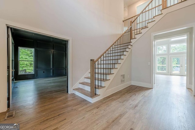 2555 Chattahoochee Ln, Cumming, GA 30041 - stairway featuring wood finished floors and a towering ceiling