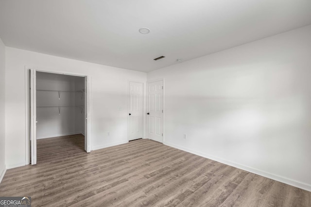 6932 Eunice Dr, Riverdale, GA 30274 - unfurnished bedroom featuring wood finished floors, baseboards, a closet, and a spacious closet