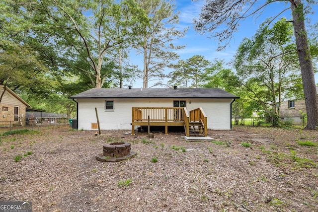 6932 Eunice Dr, Riverdale, GA 30274 - back of house with an outdoor fire pit, a wooden deck, and fence