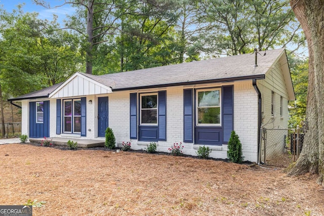 6932 Eunice Dr, Riverdale, GA 30274 - single story home with brick siding, covered porch, board and batten siding, fence, and a shingled roof
