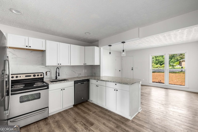 6932 Eunice Dr, Riverdale, GA 30274 - kitchen with stainless steel appliances, a sink, a peninsula, white cabinetry, and wood finished floors