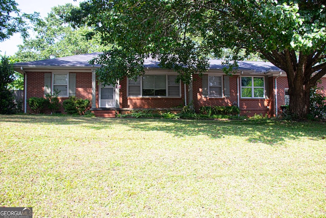 ranch-style house with brick siding and a front yard
