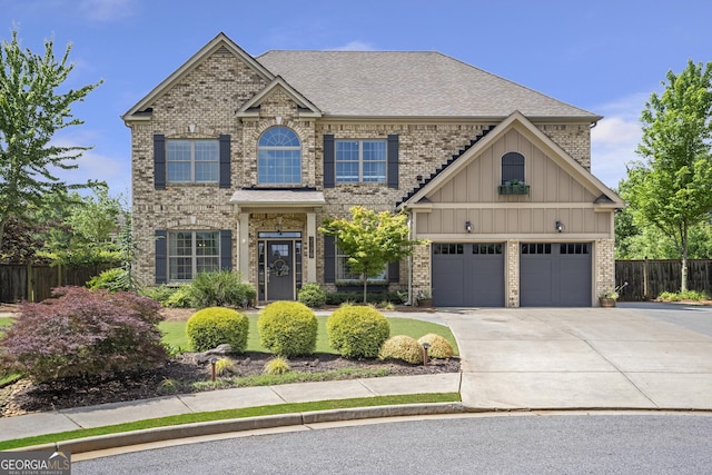 3179 Falls Crest Ct, Buford, GA 30519 - view of front of property with board and batten siding, concrete driveway, brick siding, and roof with shingles