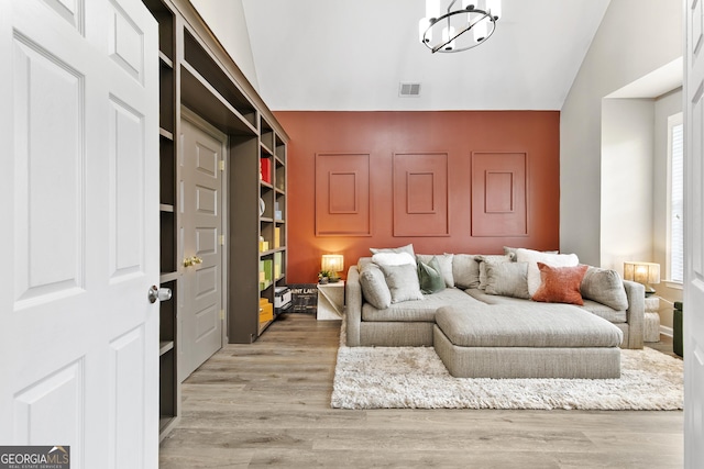 3 Tiffany Trce, Palmetto, GA 30268 - living room featuring vaulted ceiling, a chandelier, and light wood-type flooring