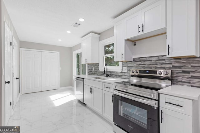 3216 Montheath Ct, Duluth, GA 30096 - kitchen featuring stainless steel appliances, a sink, light marble finish floors, light countertops, and recessed lighting