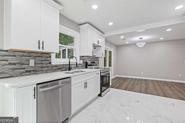 3216 Montheath Ct, Duluth, GA 30096 - kitchen featuring appliances with stainless steel finishes, a sink, tasteful backsplash, white cabinetry, and recessed lighting