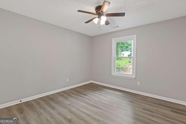 3216 Montheath Ct, Duluth, GA 30096 - spare room with wood finished floors, a textured ceiling, baseboards, and a ceiling fan