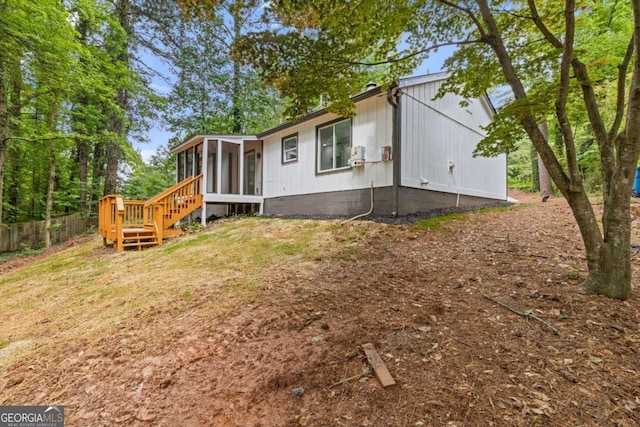 3216 Montheath Ct, Duluth, GA 30096 - view of home's exterior featuring a sunroom and fence
