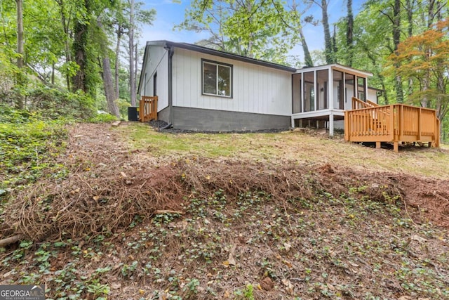 3216 Montheath Ct, Duluth, GA 30096 - view of property exterior with a sunroom and a wooden deck