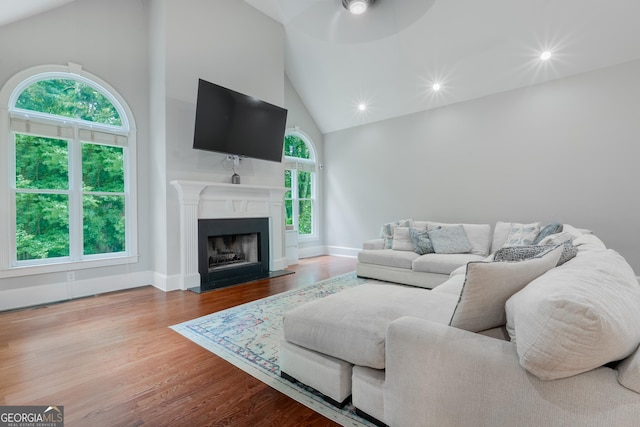 1000 Admiral Xing, Alpharetta, GA 30005 - living area featuring high vaulted ceiling, ceiling fan, wood finished floors, a fireplace with flush hearth, and recessed lighting