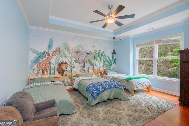 1000 Admiral Xing, Alpharetta, GA 30005 - bedroom with wood finished floors, a raised ceiling, baseboards, ornamental molding, and a ceiling fan