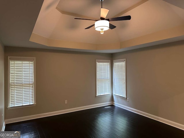 1305 Lake Forest Ln, Mcdonough, GA 30253 - spare room with baseboards, dark wood-style floors, a ceiling fan, and plenty of natural light