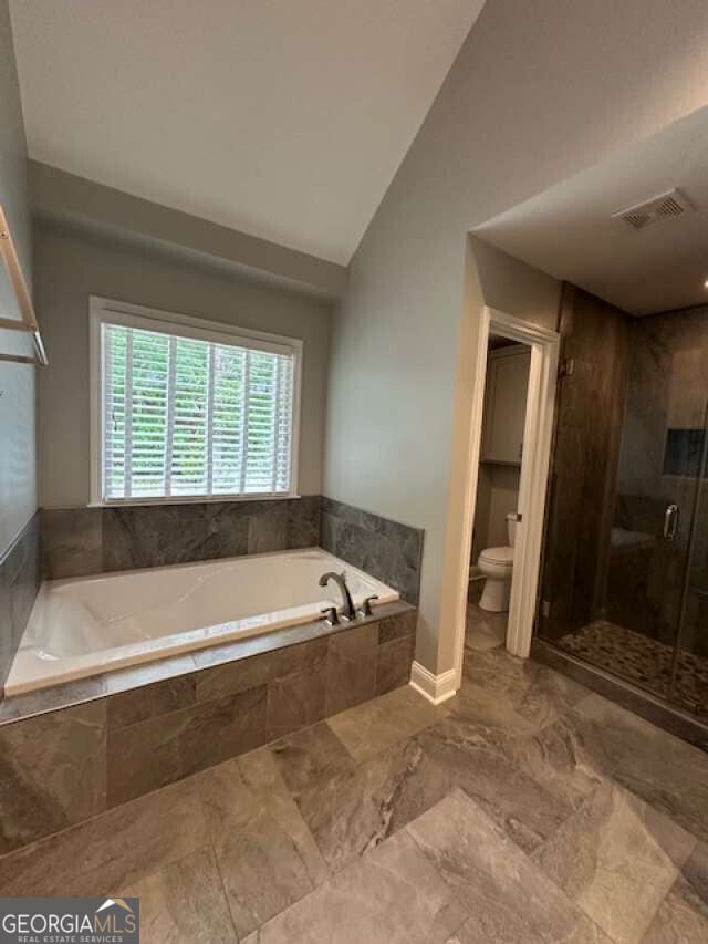 1305 Lake Forest Ln, Mcdonough, GA 30253 - full bath with a garden tub, toilet, a shower stall, lofted ceiling, and marble finish flooring
