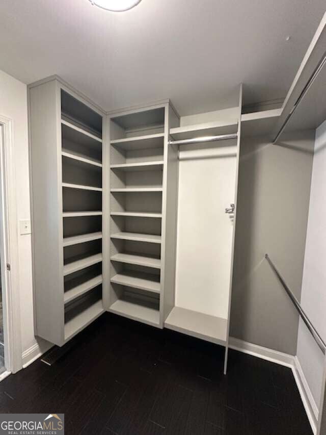1305 Lake Forest Ln, Mcdonough, GA 30253 - spacious closet with dark wood-style flooring