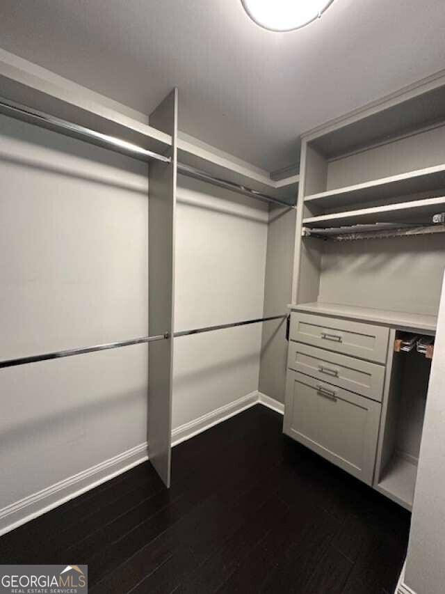 1305 Lake Forest Ln, Mcdonough, GA 30253 - spacious closet featuring dark wood finished floors
