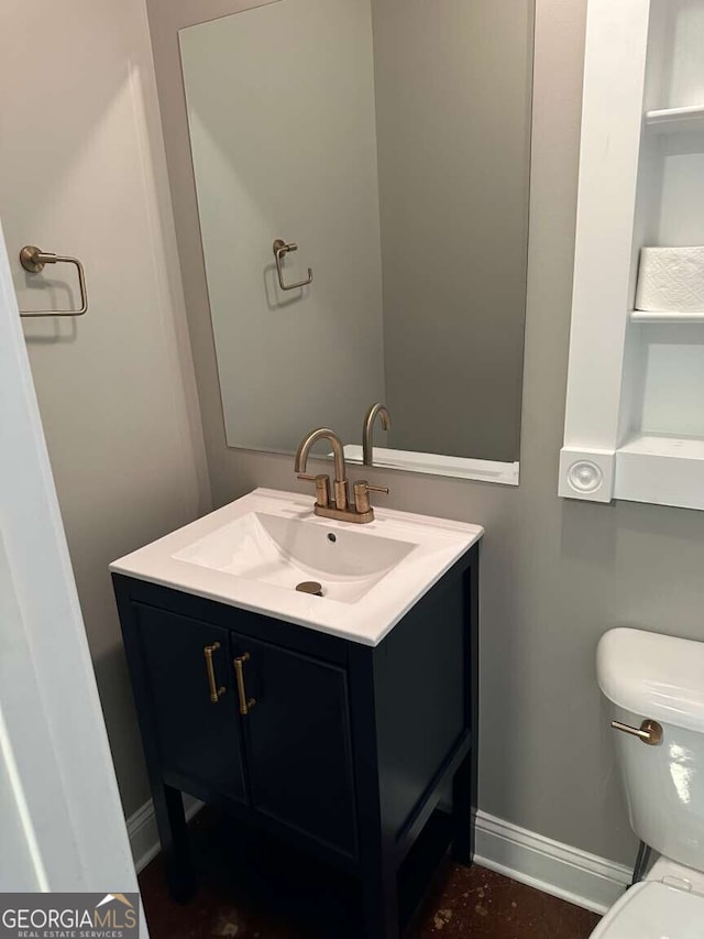 1305 Lake Forest Ln, Mcdonough, GA 30253 - bathroom featuring vanity, toilet, and baseboards