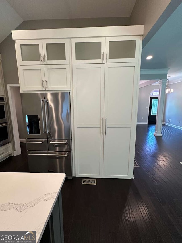 1305 Lake Forest Ln, Mcdonough, GA 30253 - kitchen with decorative columns, stainless steel appliances, dark wood-type flooring, white cabinetry, and recessed lighting