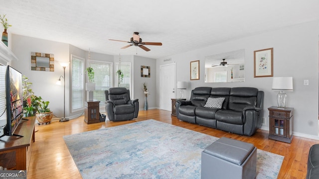 2675 Springside Ct, Douglasville, GA 30135 - living room featuring ceiling fan, baseboards, and light wood-style flooring